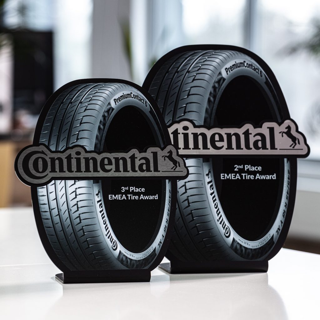 3mm laser cut and bent satin acrylic with UV print. Laminate brushed metal engraving with CO2.